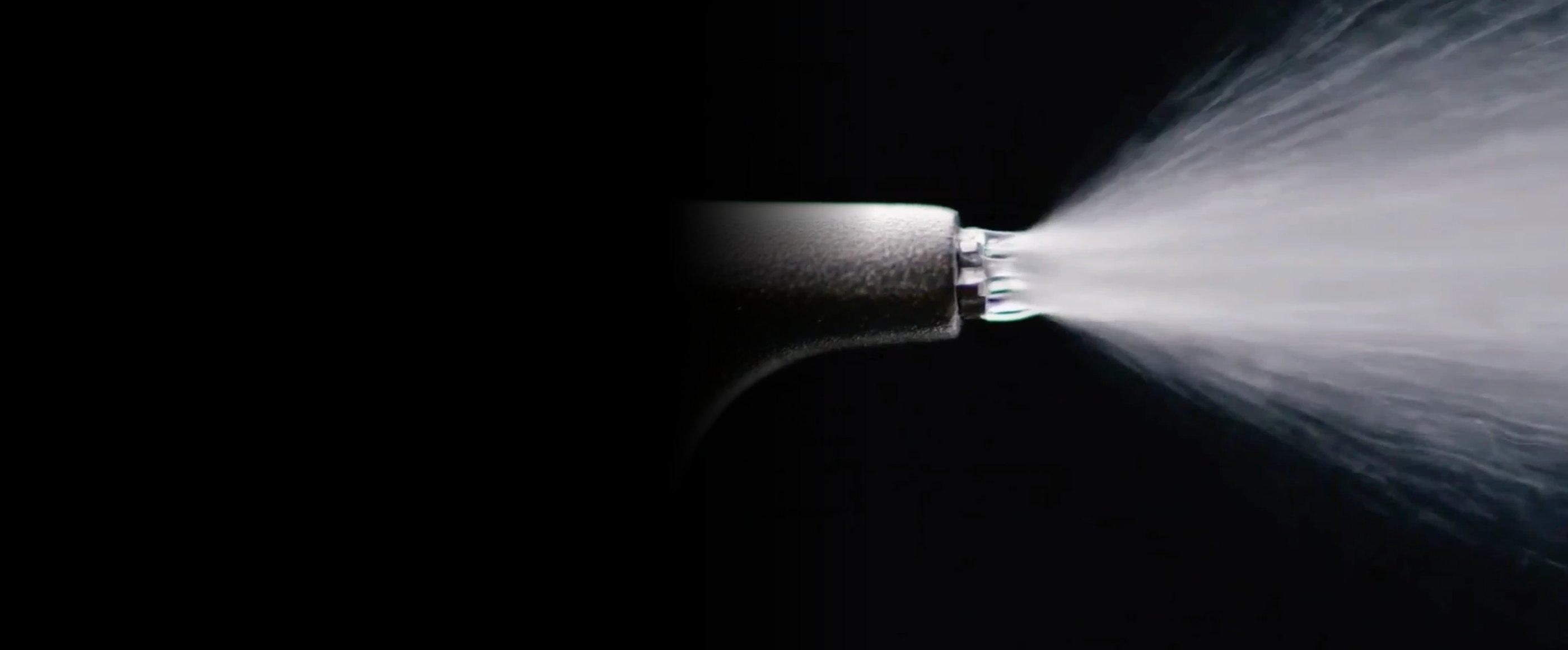 Airflow handpiece spraying warm water, air and fine erythritol powder